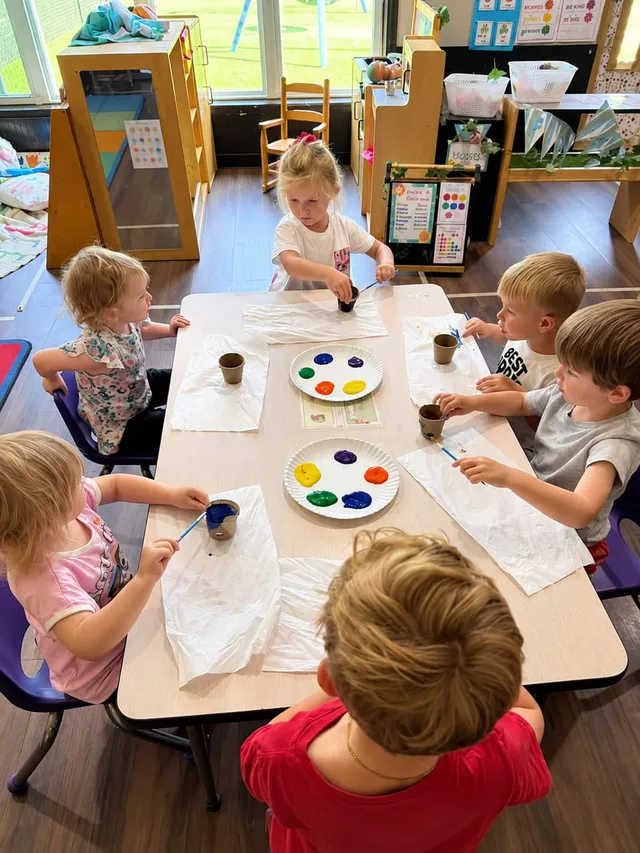 Children painting together in a Liddle Adventures Learning Academy classroom